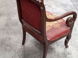 a red chair that is sitting on a cement floor