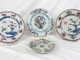 three plates with different designs on them sitting on a white surface