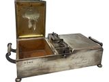 an old silver box with a horse in it on a white background