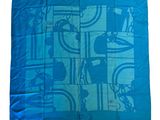the blue scarf has a picture of people on bicycles on it