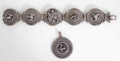 a close up of a bracelet and a pendant on a white surface