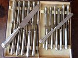 a bunch of knives in a box with a knife in it