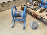 a blue hose sitting on a wooden pallet next to a metal pipe