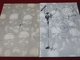 two pages of paper with drawings on them on a table