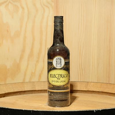 a bottle of beer sitting on top of a wooden barrel