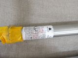 a metal tube with a yellow bag on top of it