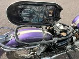 a purple motorcycle parked on the side of the road