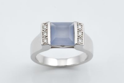 an image of a ring with a blue stone and diamonds on it