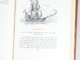 an open book with a drawing of a ship on it
