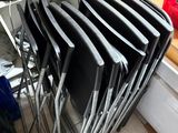 a lot of chairs that are stacked on top of each other