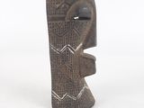 an image of a wooden sculpture of a face on a white background