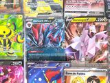 a lot of pokemon cards that are on the table