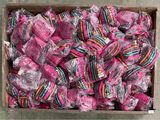 a box full of pink lollipops sitting on the floor