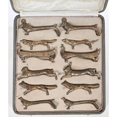 a bunch of silver dog figurines in a case