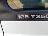 a man taking a picture of himself in the mirror of a car
