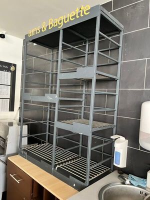a kitchen with a sink, stove, and shelves in it