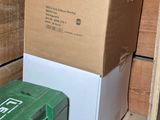 a green box sitting on a pallet next to a green box