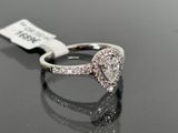 a close up of a diamond ring on a black surface