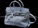 a blue purse that is sitting on a table