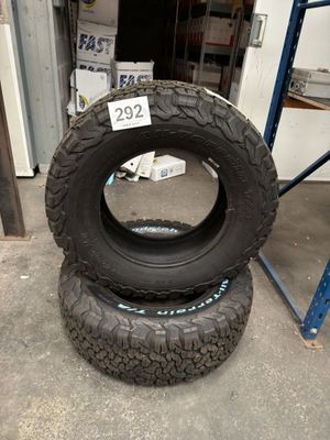 two tires are stacked on top of each other in a garage
