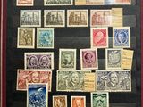 an old picture of a collection of stamps on display in a case