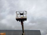 a man on a cherry picker working on the roof of a building