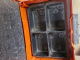 a small orange box with a bunch of ice cubes inside of it