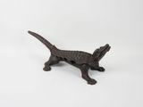 an old cast iron cat figurine on a white background