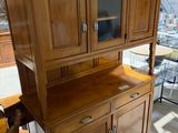 un meuble en bois surmonté d'une porte en verre