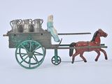 a toy horse pulling a cart with milk cans on it