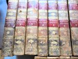 several old books are stacked on top of each other on a shelf