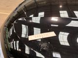 a sticker on the hood of a car that is parked in a parking lot