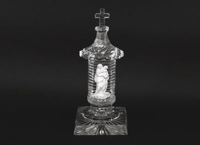 a black and white photo of a glass bottle on a stand