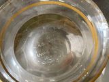a glass bowl with a gold rim sitting on a table