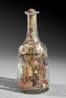 a glass bottle with a picture inside of it on a table