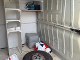 a tire in the back of a van that is being worked on