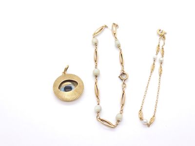 a close up of a necklace and earring on a white surface