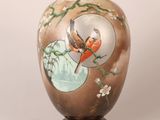 a vase with a bird and flowers painted on it