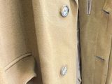 an image of a coat hanging on a clothes rack in a store