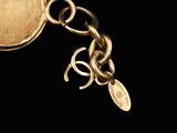 a gold keychain with a chain attached to it