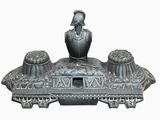 a statue of a man sitting on top of a boat