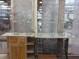 a room with a lot of glass and wood furniture