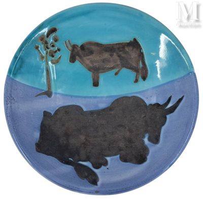 une assiette sur laquelle sont représentés une vache et un arbre