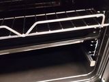 a black oven with a metal rack in it