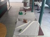 a table with a white cloth on it in the middle of a room