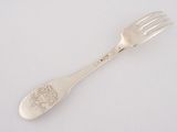 a fork that is sitting on a white surface