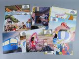 a lot of postcards of cartoon characters on a table
