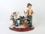 a figurine of a man and a boy working on a machine