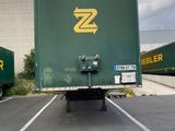 two semi trucks that are parked in a parking lot