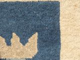 a cat that is sitting on a rug on the floor